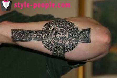 Cross tattoo on his arm. its value